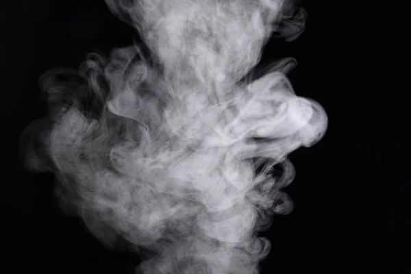 Puffs de humo extendidos sobre un fondo negro . —  Fotos de Stock