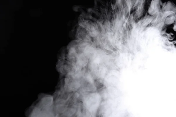 Puffs of smoke spread on a black background. — Stock Photo, Image