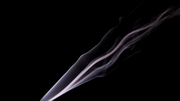 The wisps of smoke from the incense stick slowly rise up and curl with bizarre curls in rare tremors of air. — Stock Video