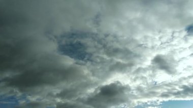 Clouds flying through the winter sky. Snow-carrying clouds driven by the wind through the cold winter sky.