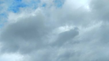 Clouds flying through the winter sky. Snow-carrying clouds driven by the wind through the cold winter sky.