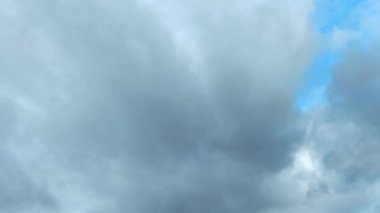 Clouds flying through the winter sky. Snow-carrying clouds driven by the wind through the cold winter sky.