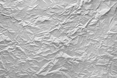 Işık tarafından vurgulanan buruşuk kağıt yüzeyine.