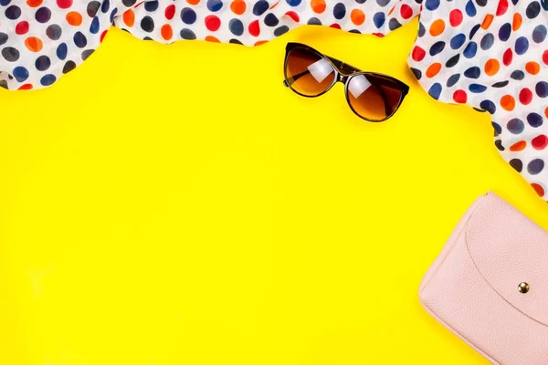 Stylish woman accessories on bright yellow background flatl lay, top view, copy space