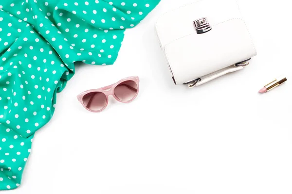 Woman fashion accessories flat lay - white purse, pink sunglasses, lipstick, scarf. Spring concept fashion collection.