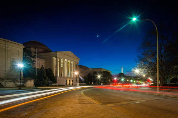 Traffic moving past the National Gallery of Art at night in Wash