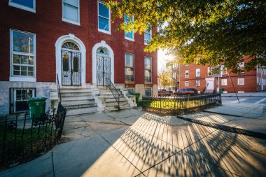 Rowhouses on Franklin Square, in Baltimore, Maryland. clipart