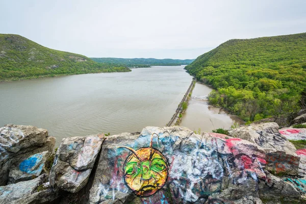 Graffiti on rocks and view of the Hudson River, at Storm King St