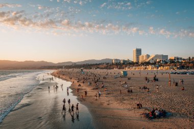 Santa Monica, Los Angeles, Calif 'te gün batımında sahili seyretmek.