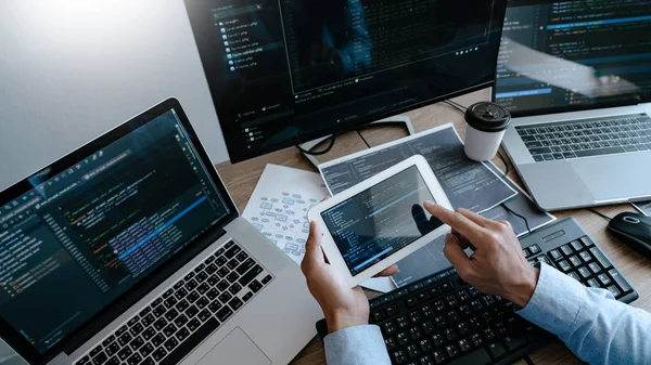 Programmer Typing Code on desktop computer, Developing programmi