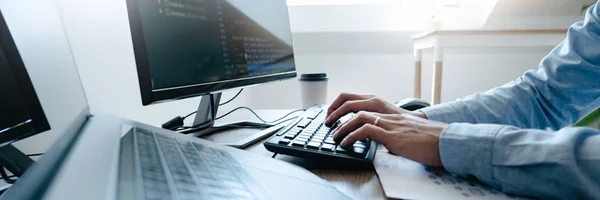 Programmer working On Computer In IT Office Typing Data Coding i