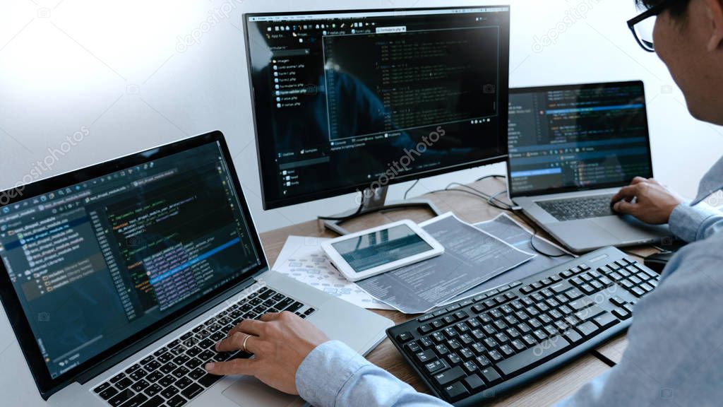Programmer Typing Code on desktop computer, Developing programmi