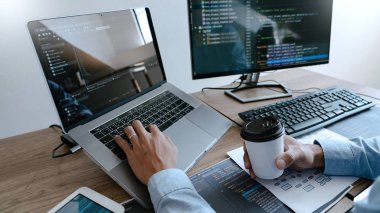 Programmer Typing Code on desktop computer, Developing programmi