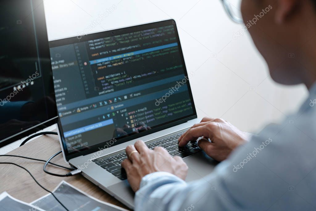 Programmer Typing Code on desktop computer, Developing programmi