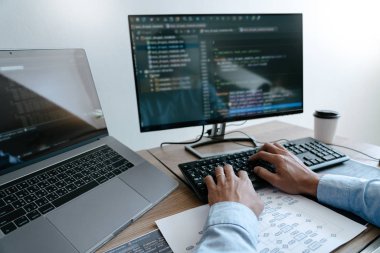Programmer Typing Code on desktop computer, Developing programmi