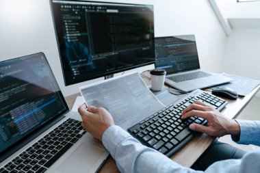Programmer Typing Code on desktop computer, Developing programmi