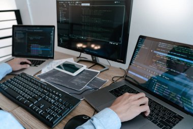 Programmer Typing Code on desktop computer, Developing programmi