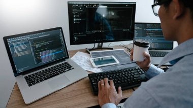 Programmer Typing Code on desktop computer, Developing programmi