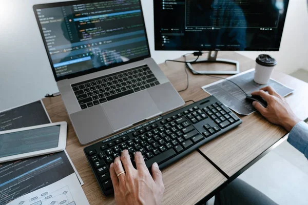 Programmer Typing Code on desktop computer, Developing programmi