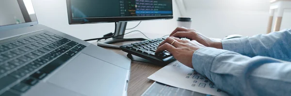 Programmer working On Computer In IT Office Typing Data Coding i