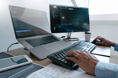 Programmer Typing Code on desktop computer, Developing programmi