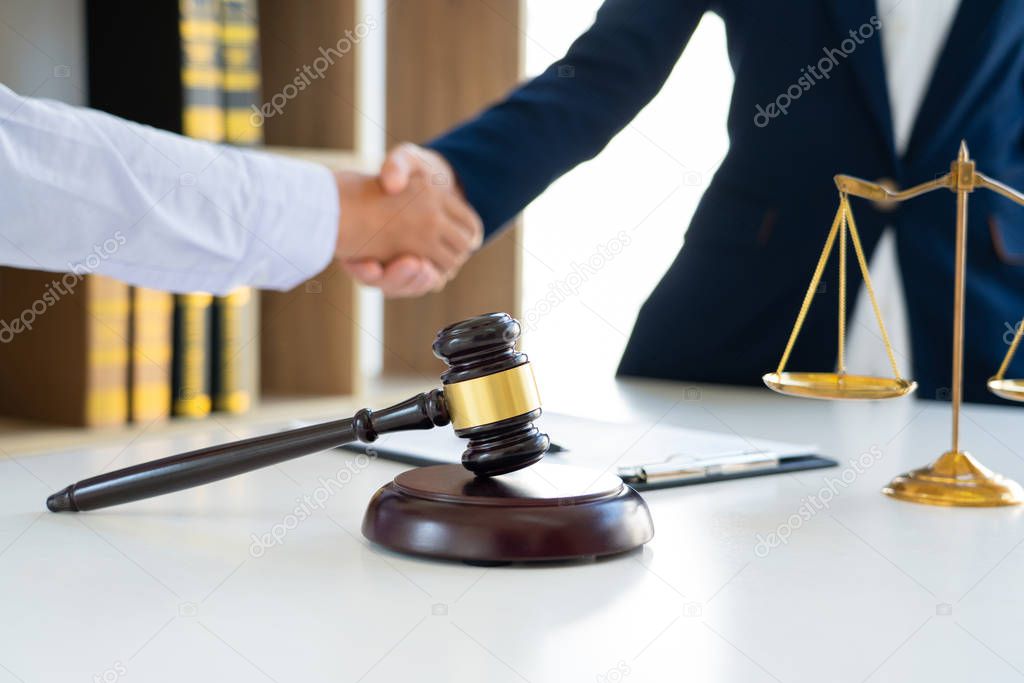 Judge And Client Shaking Hands after agreeing to enter into a contract for a court case In A Courtroom, legal services concept.
