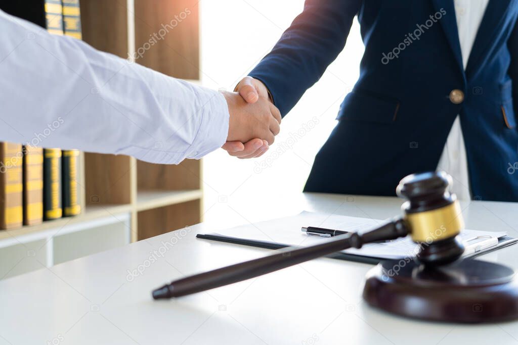 lawyers or attorneys discussing a contract agreement shaking hand after good deal contact, finishing up a meeting