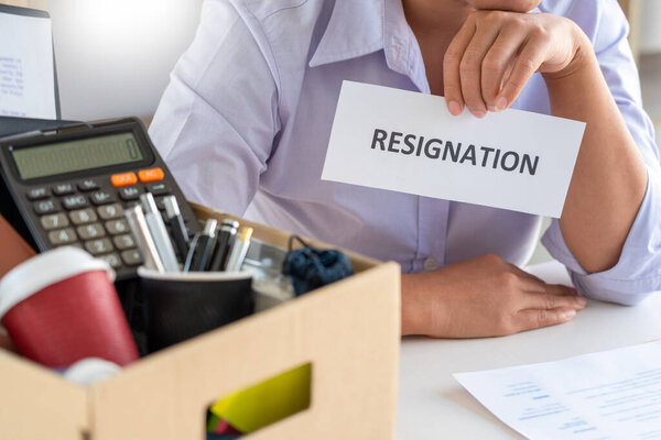 Businesswoman resigning from her job hold boxes and packing personal company for personal belongings. deciding resignation concept and changing work in future
