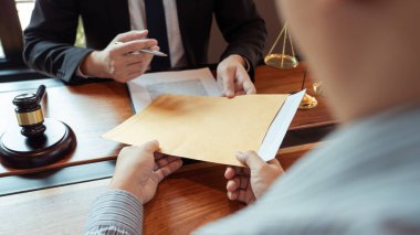Lawyer working with client discussing contract papers with brass scale about legal legislation in courtroom, consulting to help their customer clipart