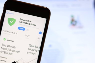 Ekranda Adguard uygulaması simgesi olan cep telefonu dizüstü bilgisayardaki web sitesini kapat. Adguard engeli ve mahremiyeti ile bulanık arkaplan. Los Angeles, California, Usa - 9 Kasım 2019, Illustrative Editorial