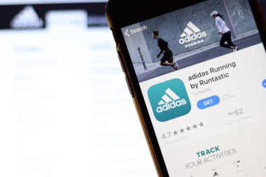 Adidas 'ın çalıştığı cep telefonu ekranda, dizüstü bilgisayardaki web sitesini kapatın. Adidas Runtastic ile bulanık arkaplan. Los Angeles, California, Usa - 9 Kasım 2019, Illustrative Editorial