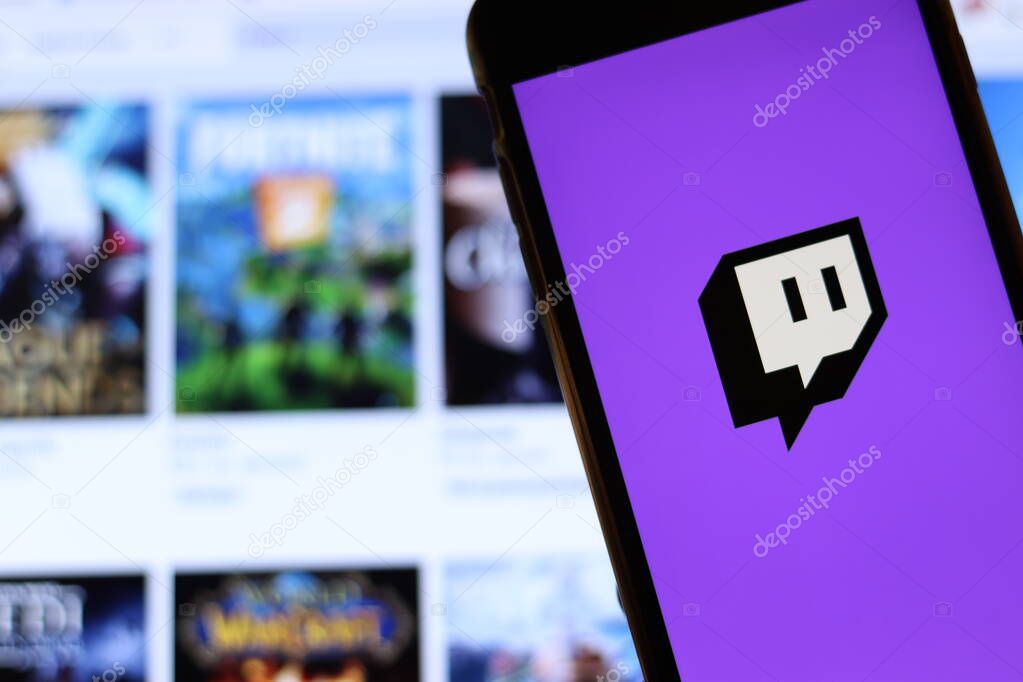 Los Angeles, California, USA - 21 November 2019: Twitch.tv logo on phone screen with icon on laptop on blurry background, Illustrative Editorial.