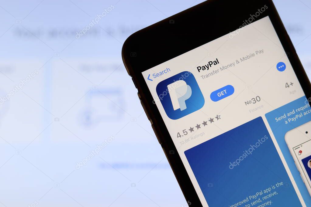 Los Angeles, California, USA - 21 November 2019: Paypal.com logo on phone screen with icon on laptop on blurry background, Illustrative Editorial.