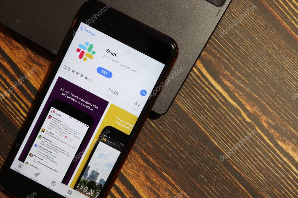 Los Angeles, California, USA - 3 December 2019: Slack App Logo on phone screen with laptop flat lay, Illustrative Editorial.