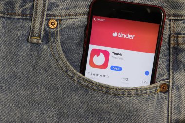 Los Angeles, California, Usa - 5 Aralık 2019: Kot pantolonun cebindeki telefon ekranında Tinder uygulama simgesi. Açık kot arka planlı İphone 'daki Uygulama Mağazası logosu, Resimli Editör