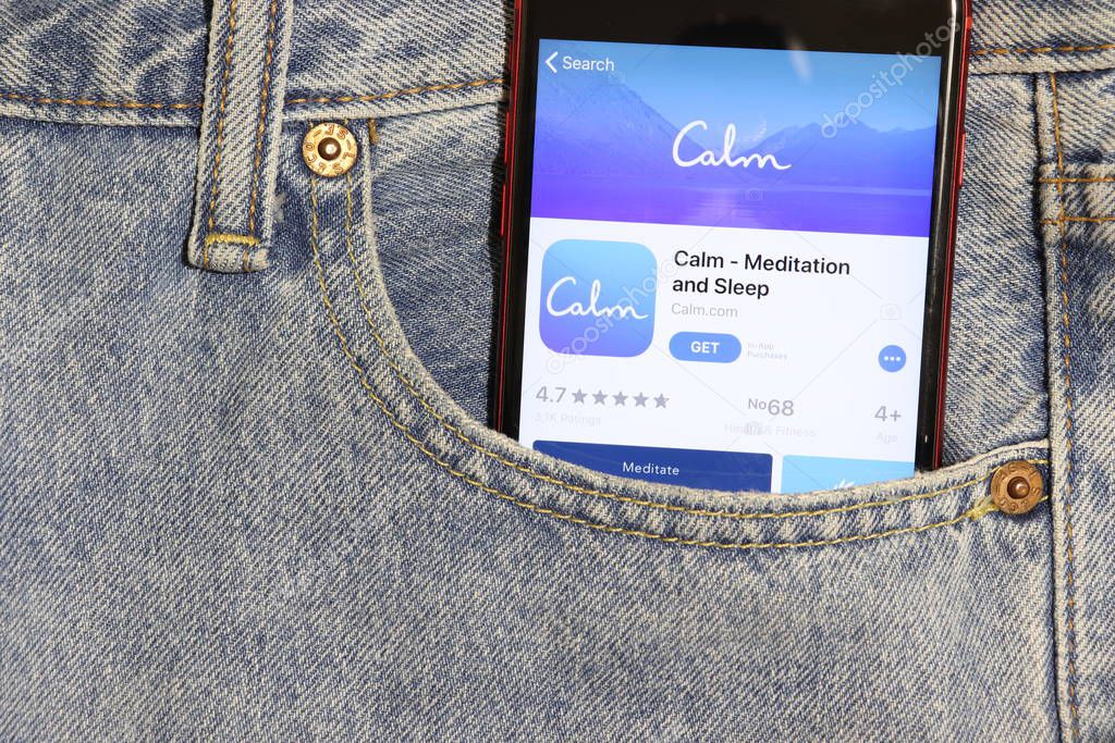 Los Angeles, California, USA - 5 December 2019: Calm Meditation and Sleep app icon on phone screen in blue jeans pocket. App Store logo on Iphone with light denim Background, Illustrative Editorial.