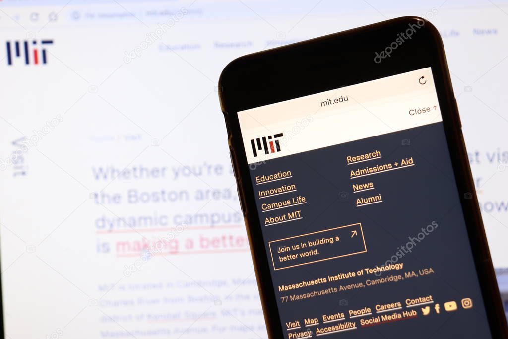 Los Angeles, California, USA - 7 December 2019: Phone screen with Massachusetts Institute of Technology MIT website page on blurry background with admission page on laptop. Higher education concept, Illustrative Editorial.