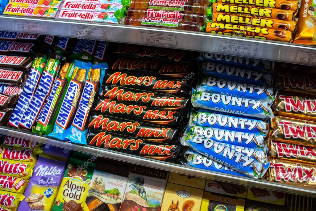 Saint-Petersburg, Russia - 30 December 2019: Mars, Bounty, Twix, Snickers, Miller and Frutella in Pulkovo Airport, Illustrative Editorial.