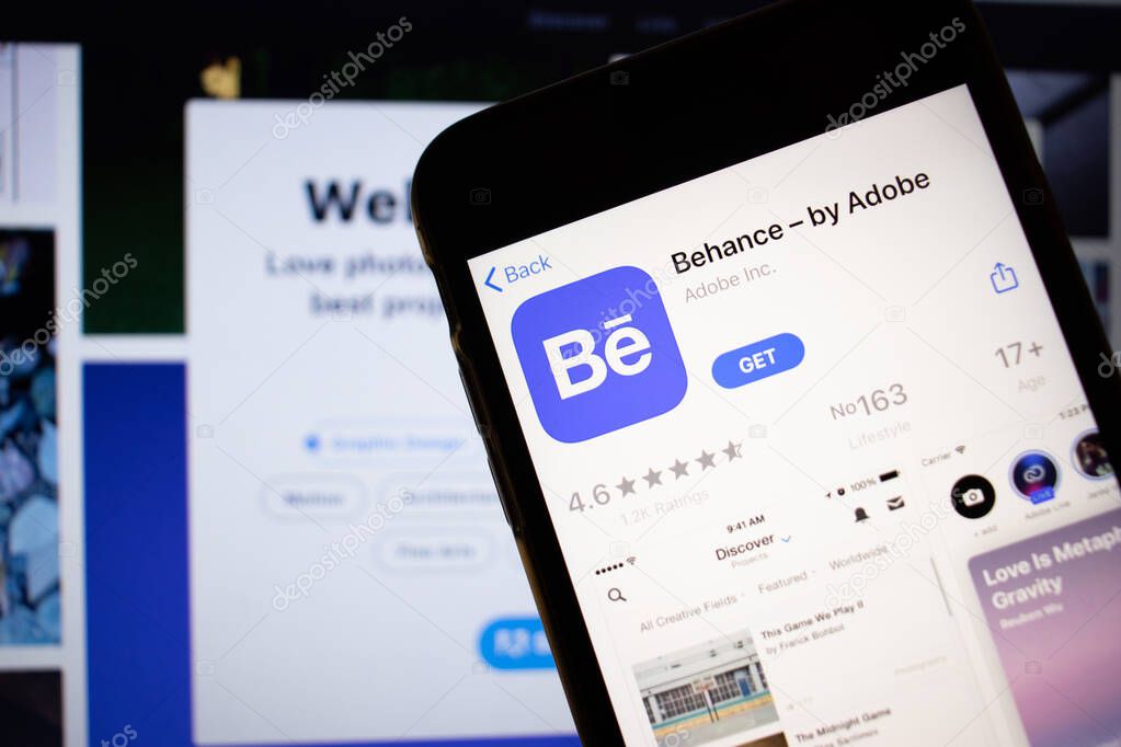 Saint-Petersburg, Russia - 10 January 2020: Mobile phone with Behance by Adobe icon on screen close up with website on laptop, Illustrative Editorial.
