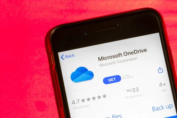 Los Angeles, California, USA - 22 January 2020: Microsoft OneDrive logo on phone screen flat lay with red background, Illustrative Editorial — Stock Photo, Image