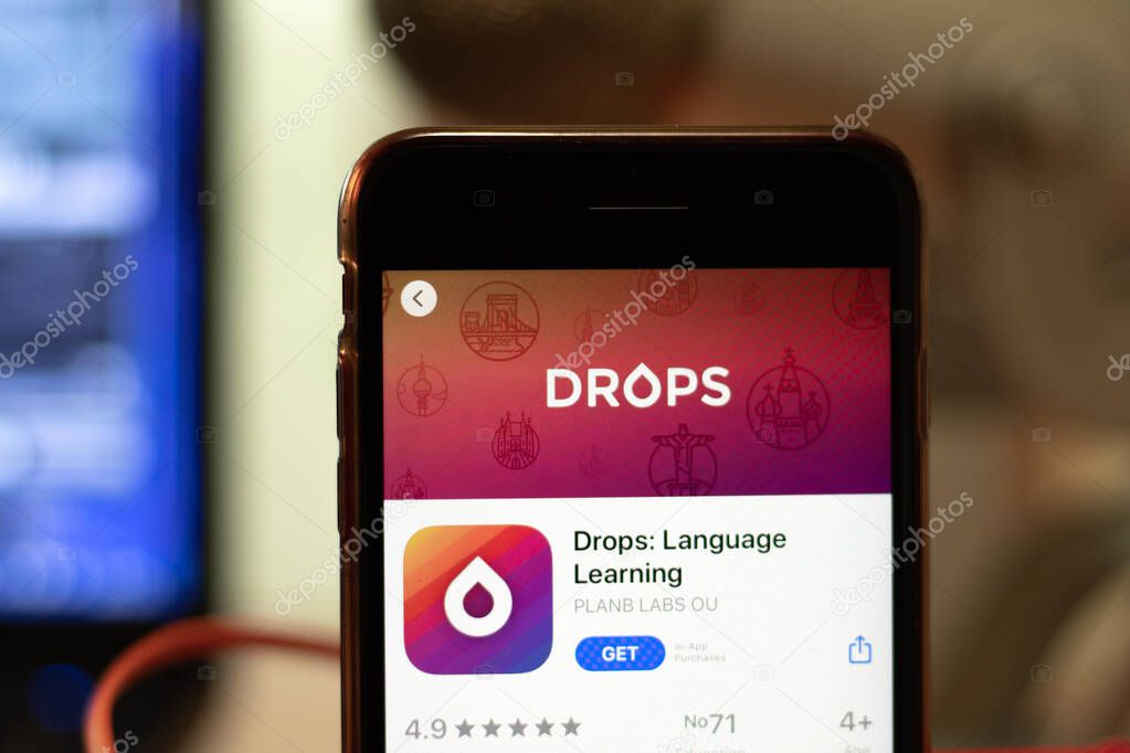 Los Angeles, California, USA - 16 April 2020: Drops Language Learning logo on screen close up. App store icon visible on phone display with blurry background, Illustrative Editorial.