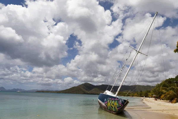 Sainte-Anne, Martinique, FWI - Graffiti on an abandoned beached sailboat in Pointe Marin beach