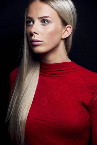 Close-up portrait of a blonde woman in red dress — Stock Photo, Image