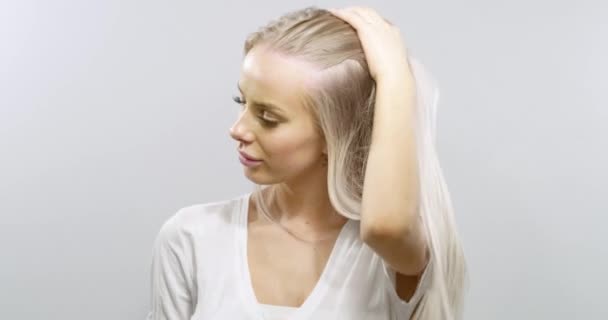 Slow motion portrait of a smiling blonde womans hair blowing in the wind — Stock Video