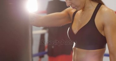 Onun koluna kum torbası ile kadın boksör portresi