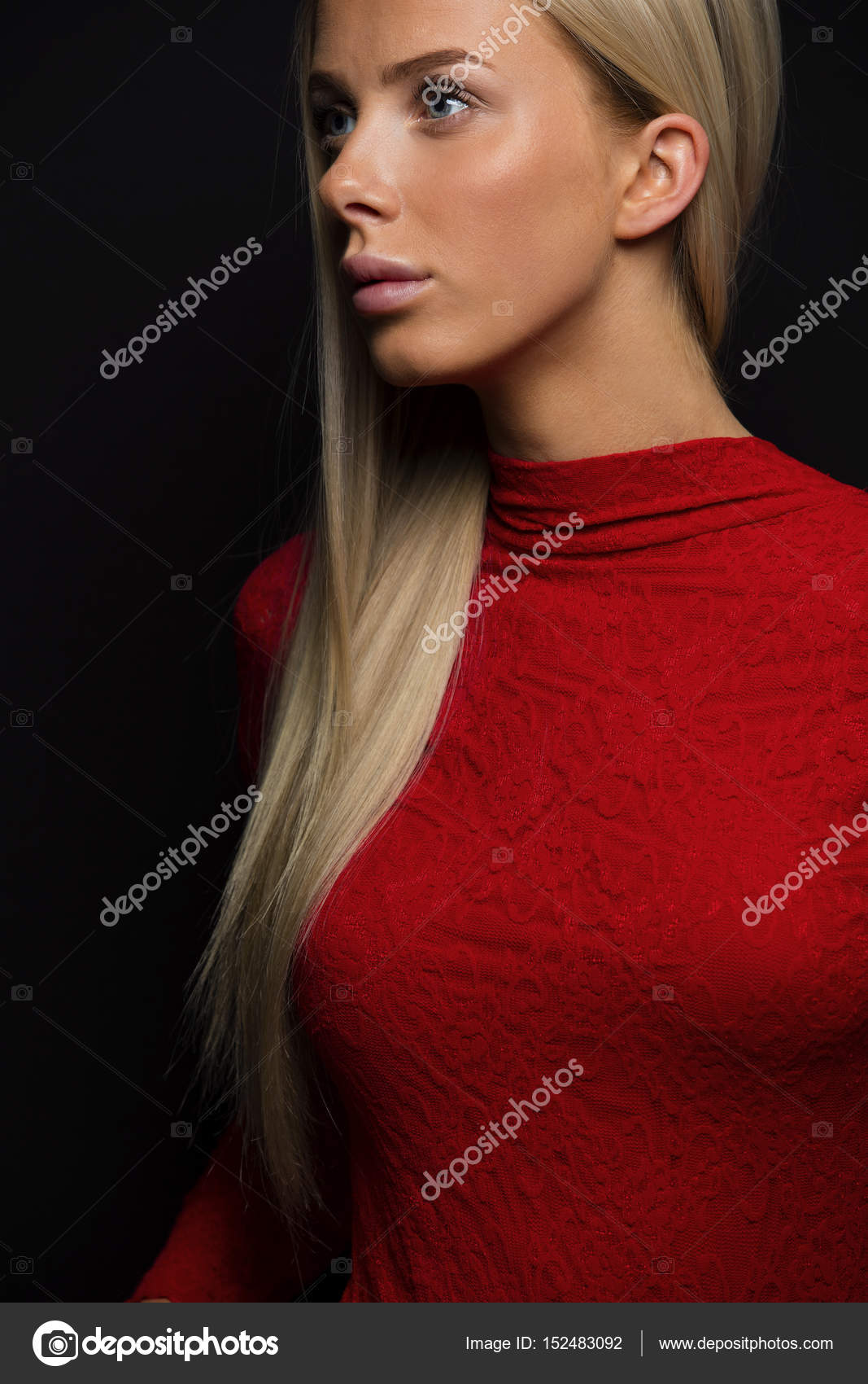 Dark Portrait Of A Pretty Blonde Woman In Red Dress On Black