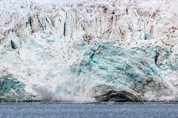 Calving ice of a massive glacier at Svalbard Royalty Free Stock Images