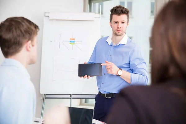 Businessman Showing Tablet Computer To Colleagues — Stock Photo, Image