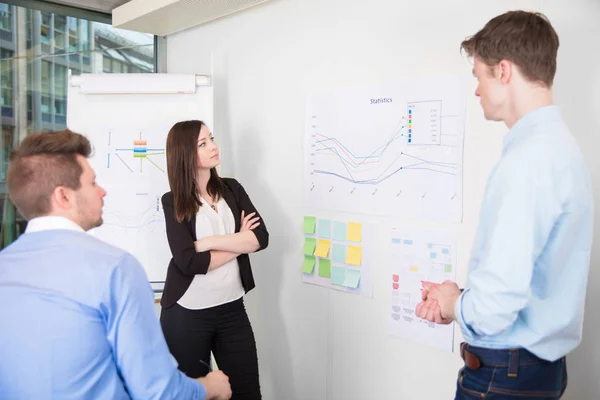 Business People Discussing Over Line Graph In Office — Stock Photo, Image