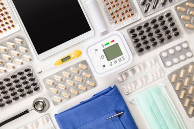 Tablet bilgisayar ve Scrubs ile kan basıncı makine tarafından hapları